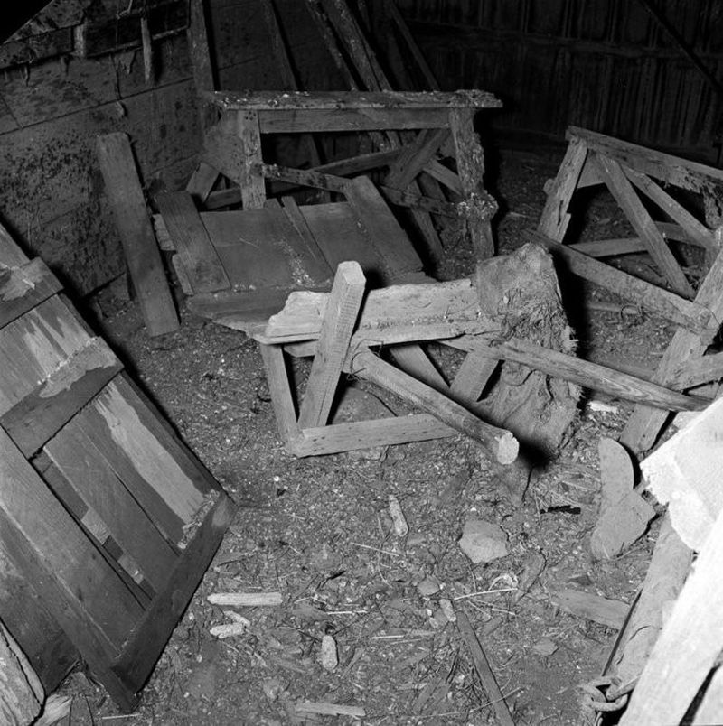 A black and white image of a wooden wheelbarrow and other farm equipment that is linked to Viola Hyatt's crimes.