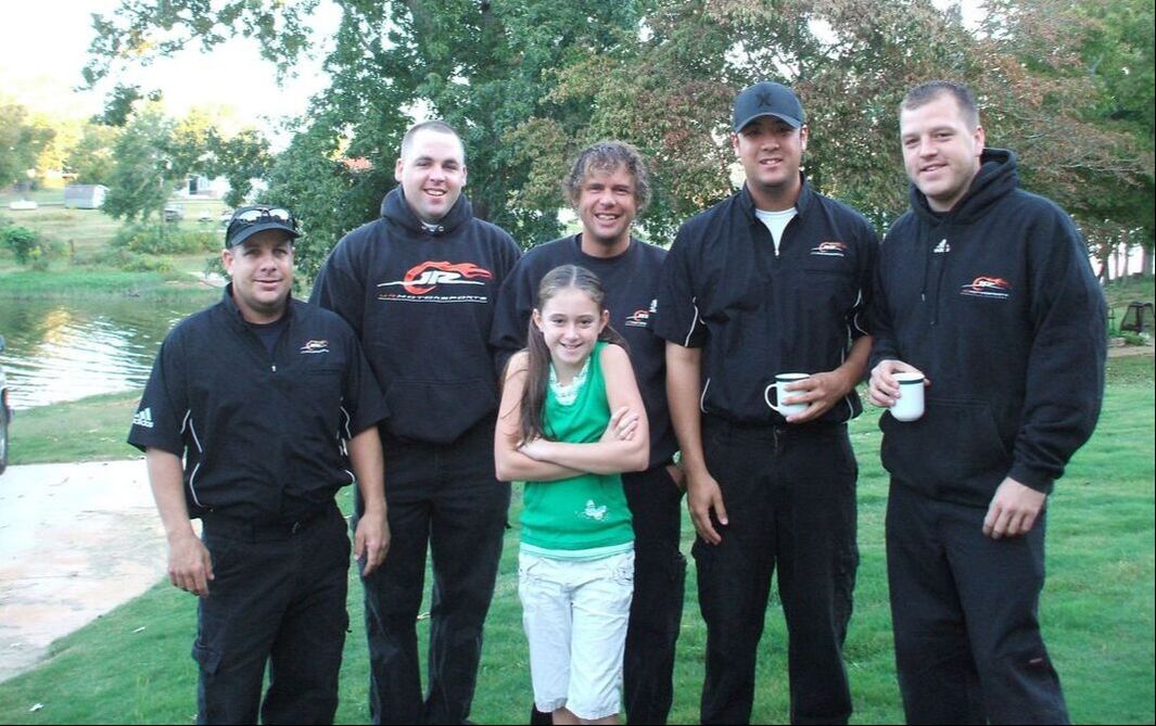 Elise standing with the JR motorsports crew