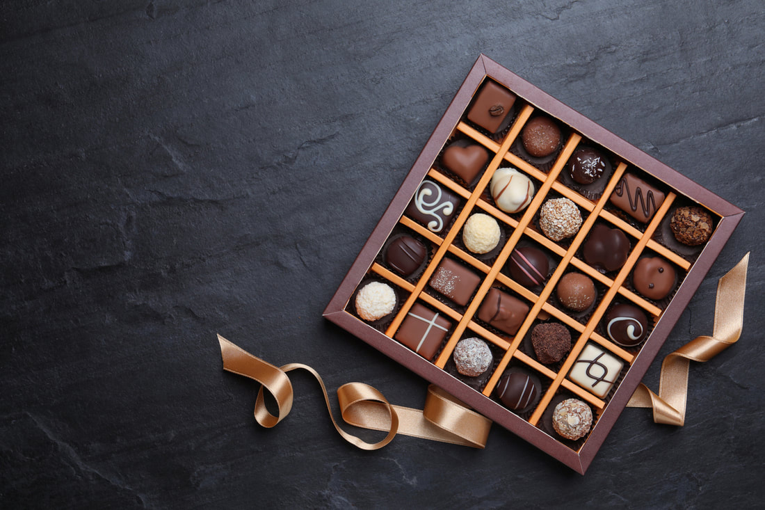 A box of chocolates on a black background.